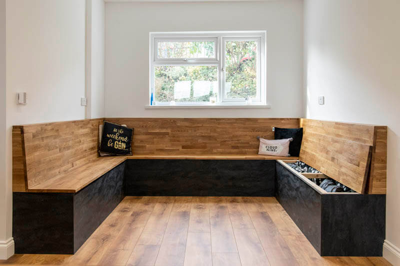This large dining area features lift-up bench seating