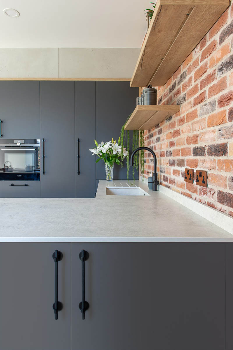 Grey Kitchen With Brick Feature Wall